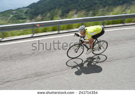 stock-photo-race-biker-by-road-cycling-downhill-241714354.jpg